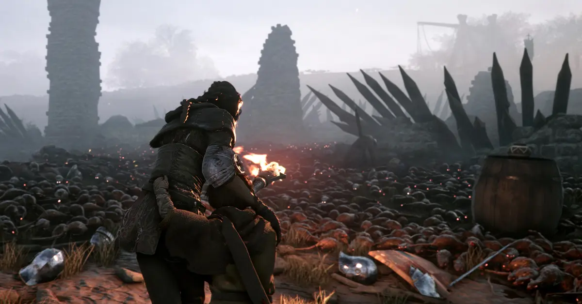 Amicia usa una torcia per respingere gli sciami di ratti in A Plague Tale Innocence