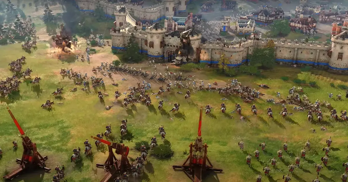 Screenshot di gioco di Age of Empires IV che mostra un assedio medievale su larga scala con trabucchi e unità di cavalleria