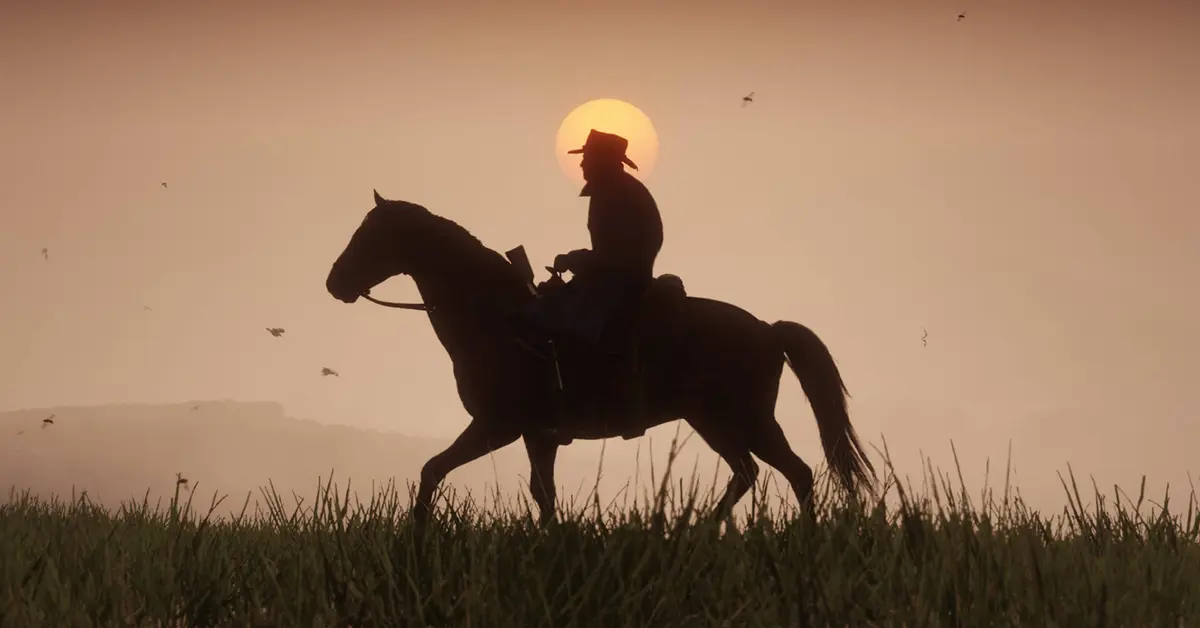 Arthur Morgan a cavallo durante un tramonto in Red Dead Redemption 2.