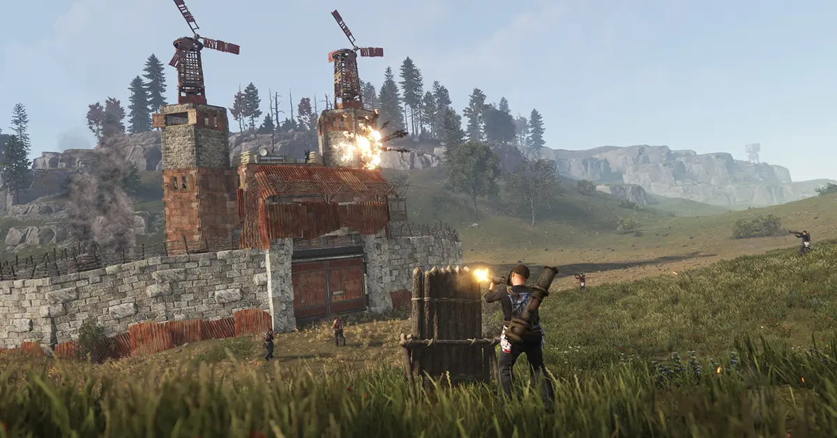 Giocatori che difendono una base pesantemente fortificata durante un raid multigiocatore in Rust