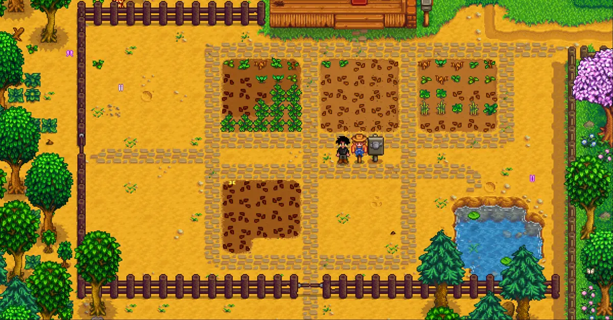 Una vivace radura di una fattoria piena di vegetazione in una soleggiata giornata primaverile a Stardew Valley.
